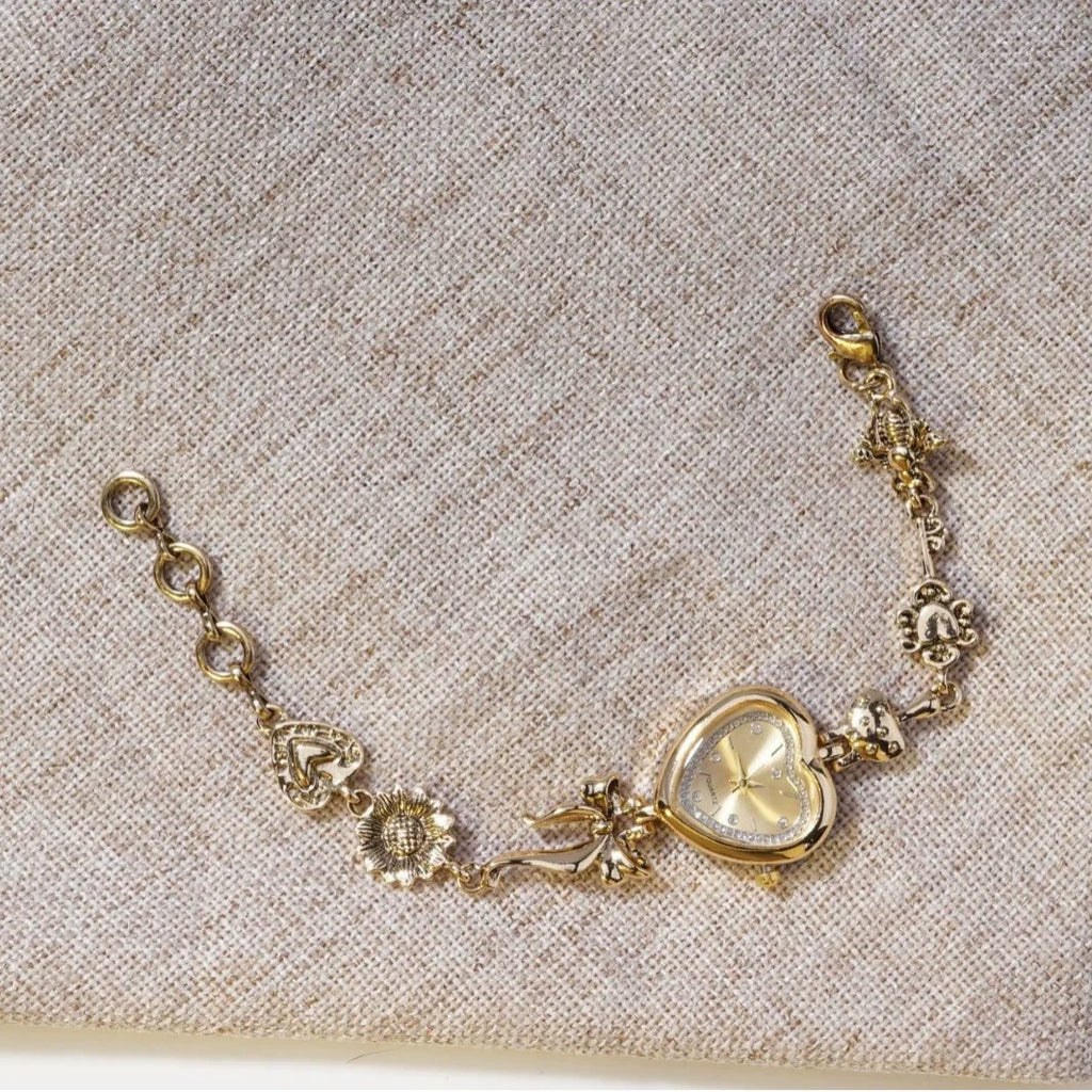 Heart Case Bracelet Watch — Gold-Tone, Crystal Bezel, Champagne Dial & Bow Charm Chain, Women
